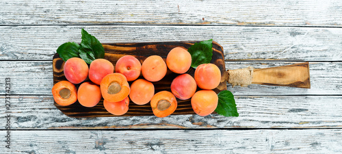 Apricots on a white wooden background. Rustic style. Top view. Free space for your text.