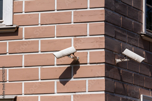 two surveillance cameras at the corner of the building. home security