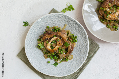 Ossobuco alla milanese - Lombard cuisine of cross-cut veal shanks, made with white wine, broth and green peas.