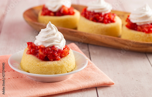 A Single Serve Strawberry Shortcakes with Strawberry Sauce and Whipped Cream photo