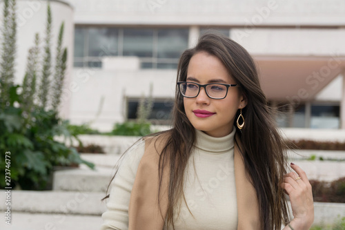 Pretty woman in glasses looking away