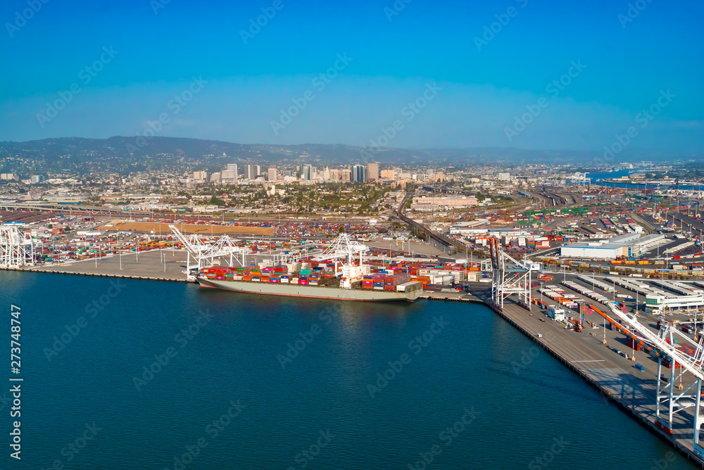 Oakland Harbor port terminal with cargo ship and shipping containers