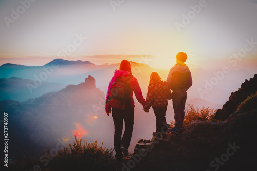 mother with kids travel in sunset mountains