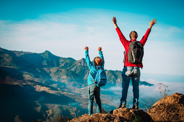 father and son travel in nature, family hiking in mountains
