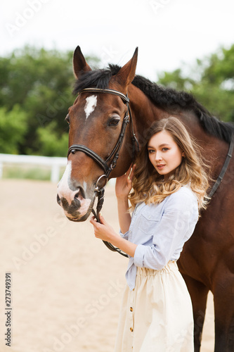 Portrait of young pretty cheerful woman with horse at summer  © ulza