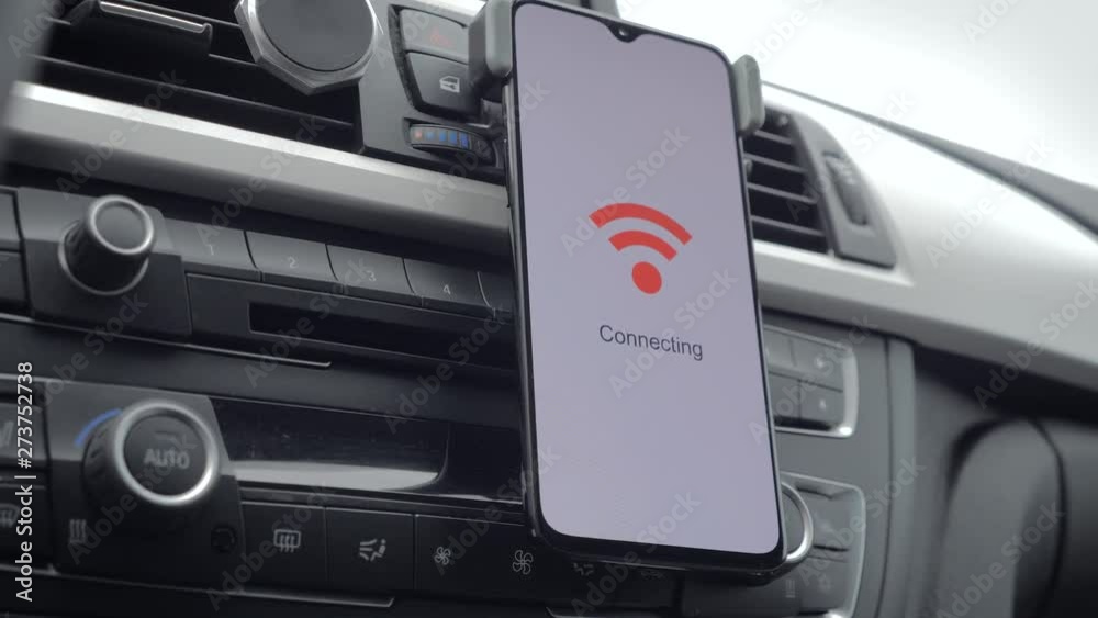 a smart phone on the dashboard of a car connects to wifi. Sliding motion a smart phone on the dashboard of a car connects to wifi. Sliding motion