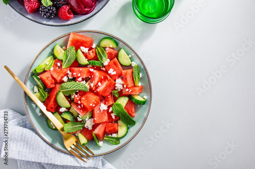 Summer salads with watermelon and cucumbers, berries and ice cream