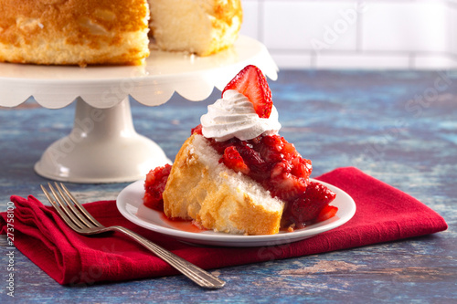 Photo Slice of Strawberry Short Cake Made with Angel Food Cake and Strawberry Sauce