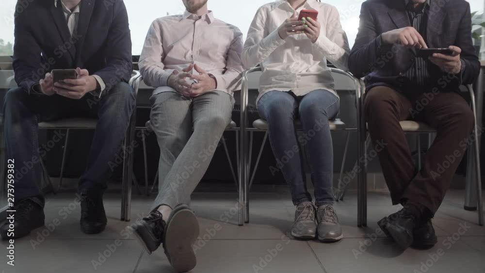 businessmen are waiting for an interview in the lobby of the office