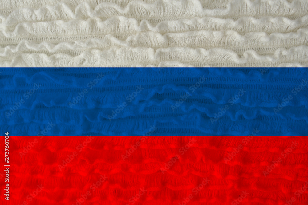 beautiful national flag of the country of Russia on a soft background texture of knitted wool with small frills of canvas