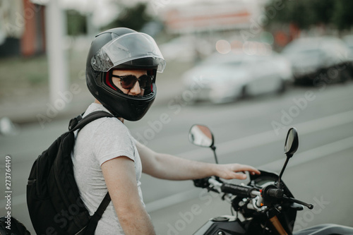 man enduro motorcycle driver in the city. biker in a helmet.
