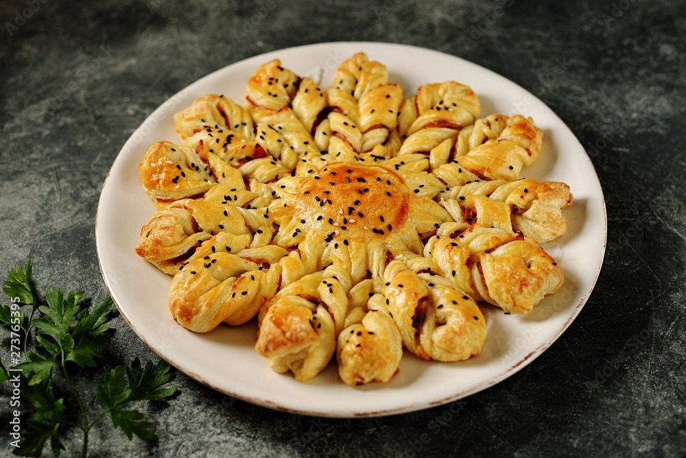 Puff pastry pie with ham and cheese. Homemade delicious pastries. Top view. Puff pastry pie with ham and cheese. Homemade delicious pastries. Top view.