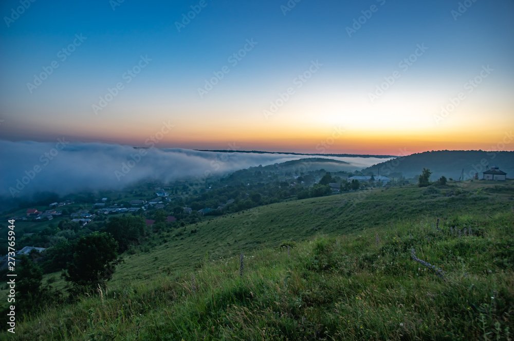 Foggy morning in the village on the river bank