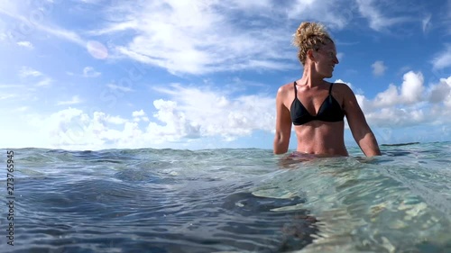 woman at exuma island with stingrays in the water