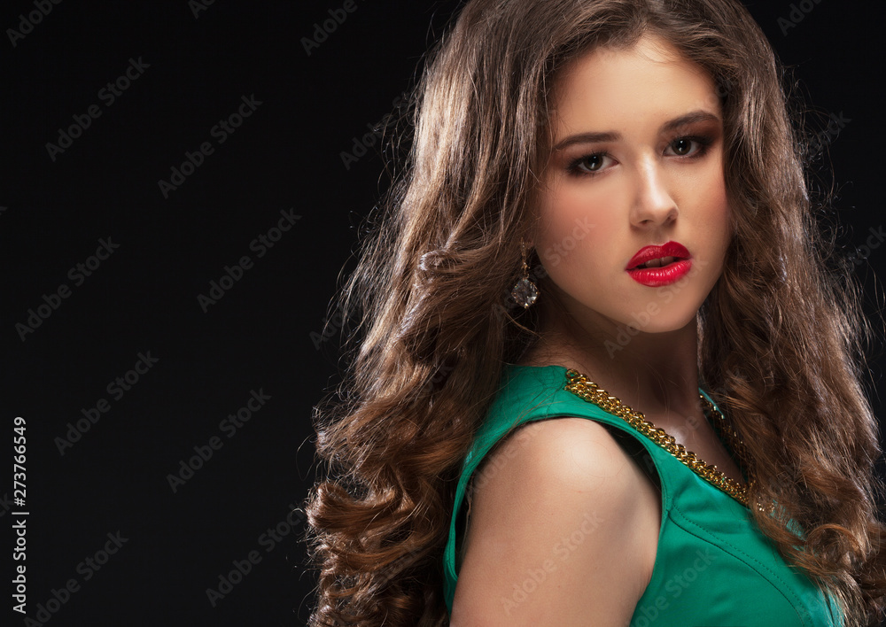 Obraz premium Brunette girl with long and volume shiny wavy hair.Beautiful model with curly hairstyle, close up portrait. Beauty concept.