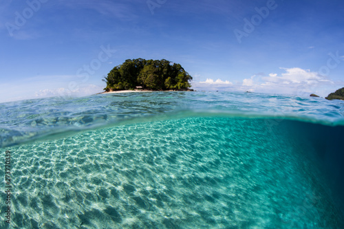 Bright sunlight ripples across the shallow, sandy seafloor in the Solomon Islands. This tropical and remote region is known for its amazing marine biodiversity. © ead72