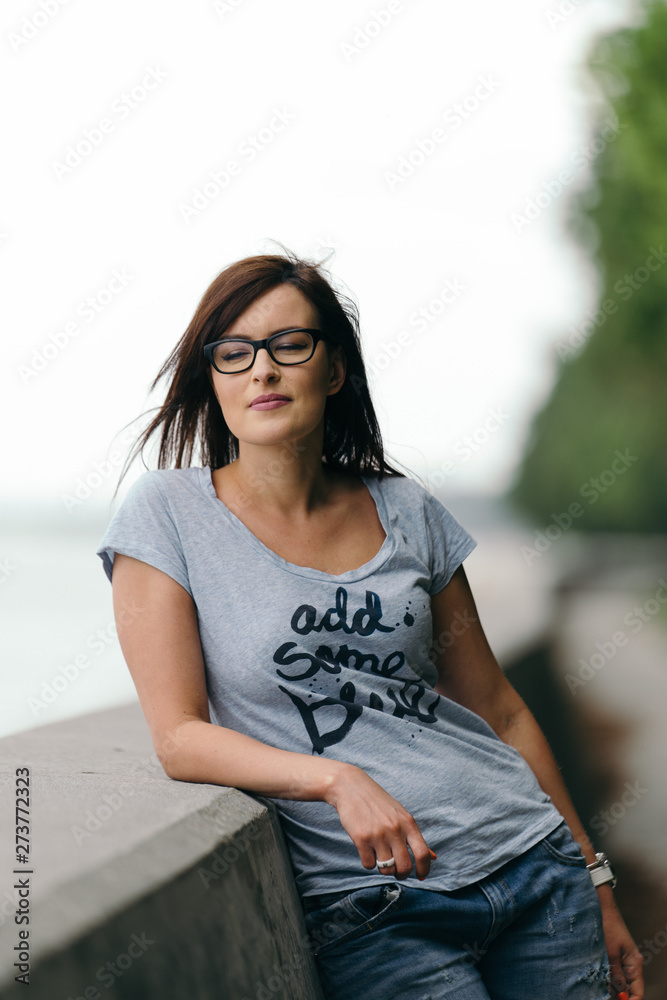 Fototapeta premium Happy young woman portrait taken on the baltic sea coastline during summer. 