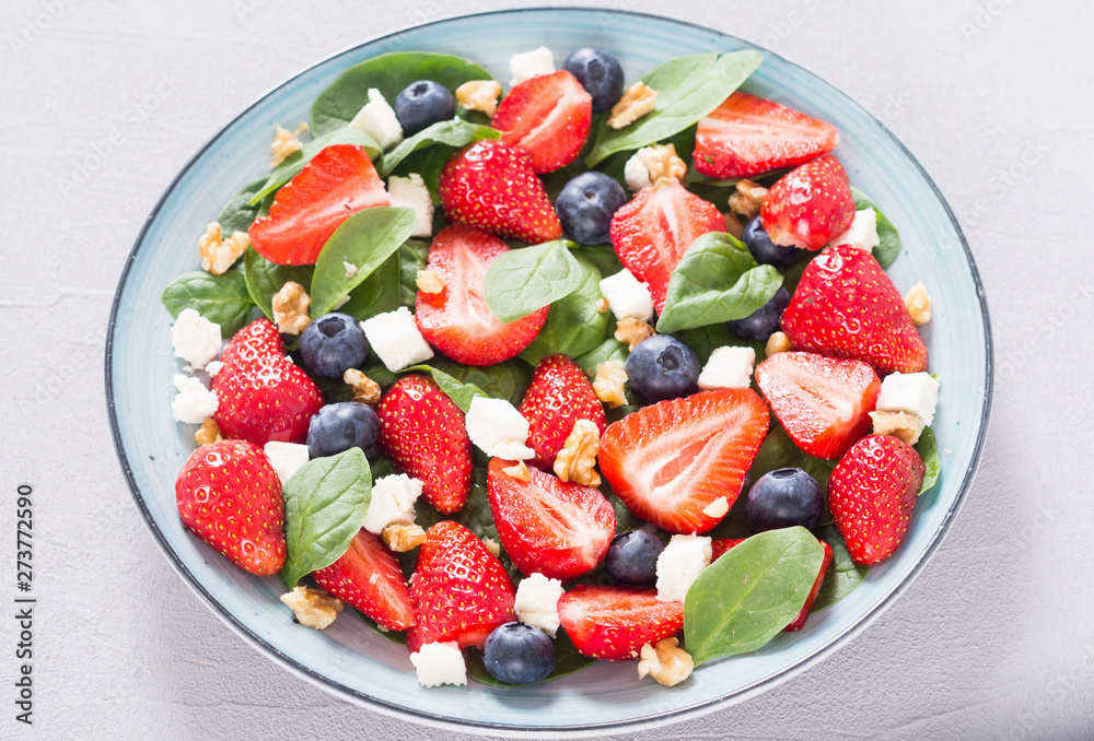 Summer Strawberry salad with spinach , cheese , nuts and blueberry Summer Strawberry salad with spinach , cheese , nuts and blueberry