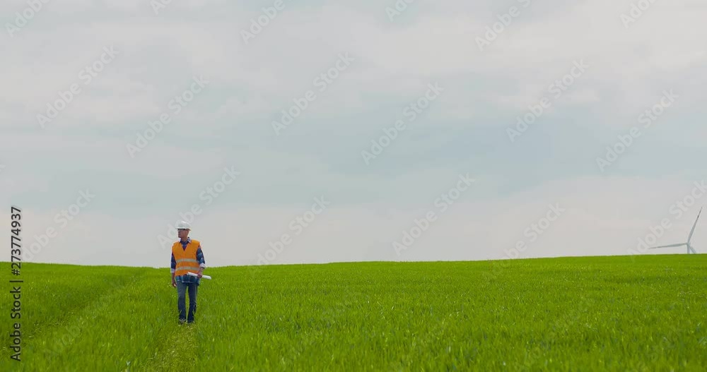 Male Engineer Working While Holding Blueprint Male Engineer Working While Holding Blueprint