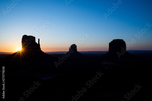 The rising sun over Monument Valley