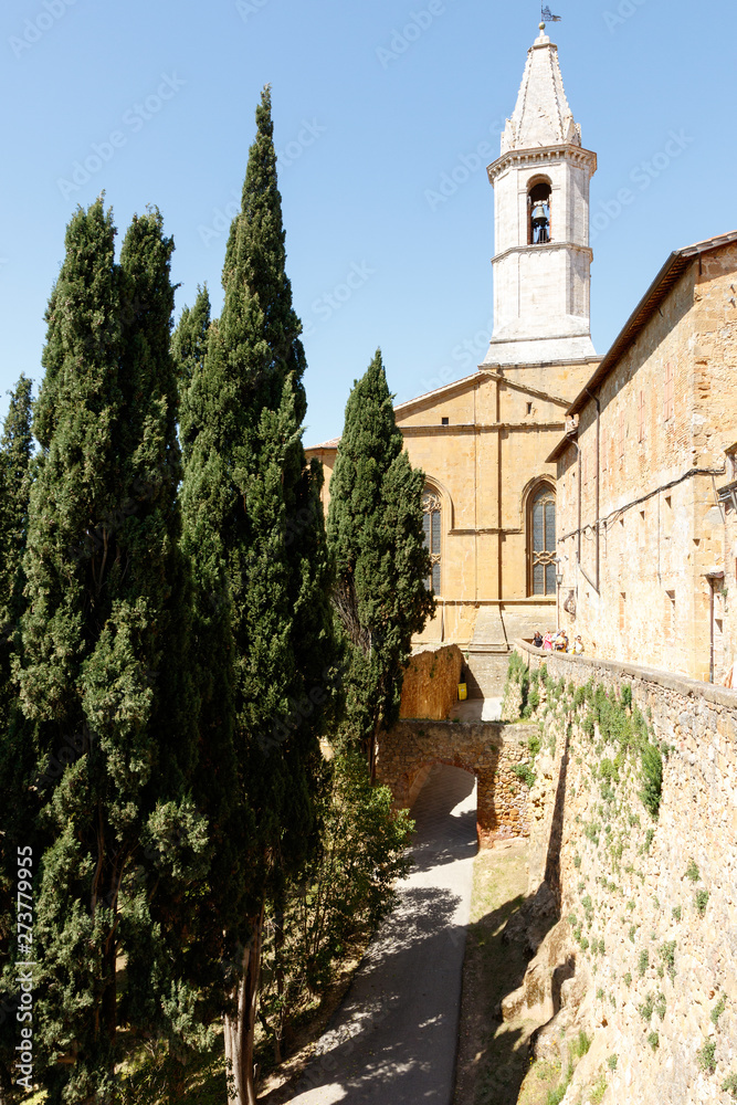Church in PIenza, Tuscany, Italy with cypress trees