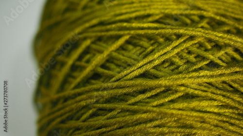 Closeup green colored yarn ball.