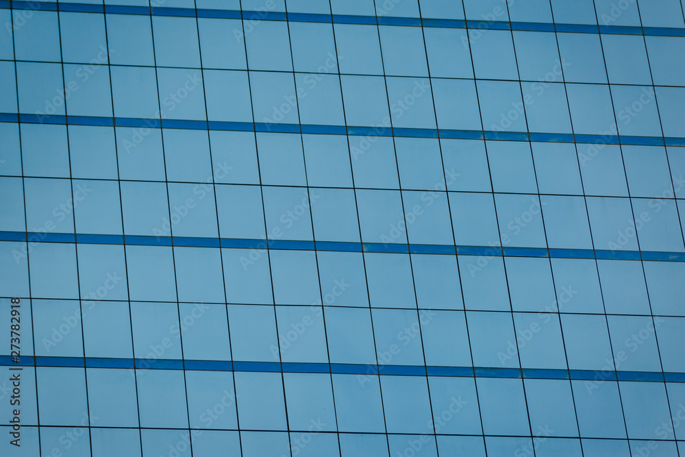 Blue glass windows of office building Blue glass windows of office building