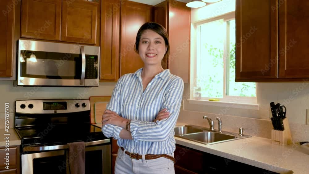 young asian local girl in ancient kitchen clean up desk table by rag. lifestyle at home in country america. beautiful mother housewife indoor doing housework turn face camera smiling attractive. young asian local girl in ancient kitchen clean up desk table by rag. lifestyle at home in country america. beautiful mother housewife indoor doing housework turn face camera smiling attractive.