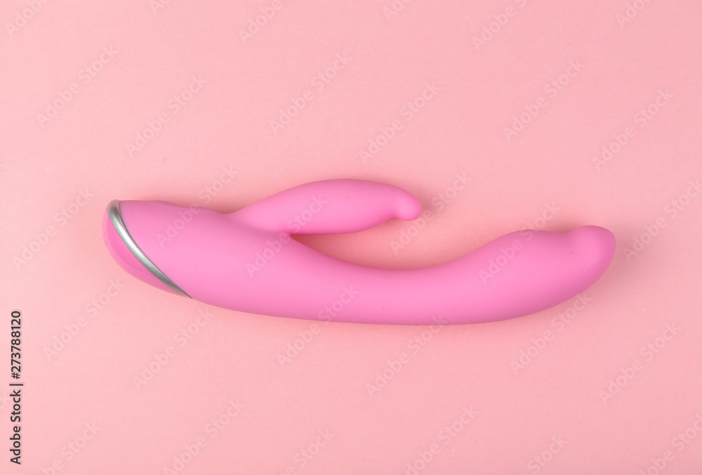 Beautiful evenly lit pink dildo on a glamorous background with copy space.