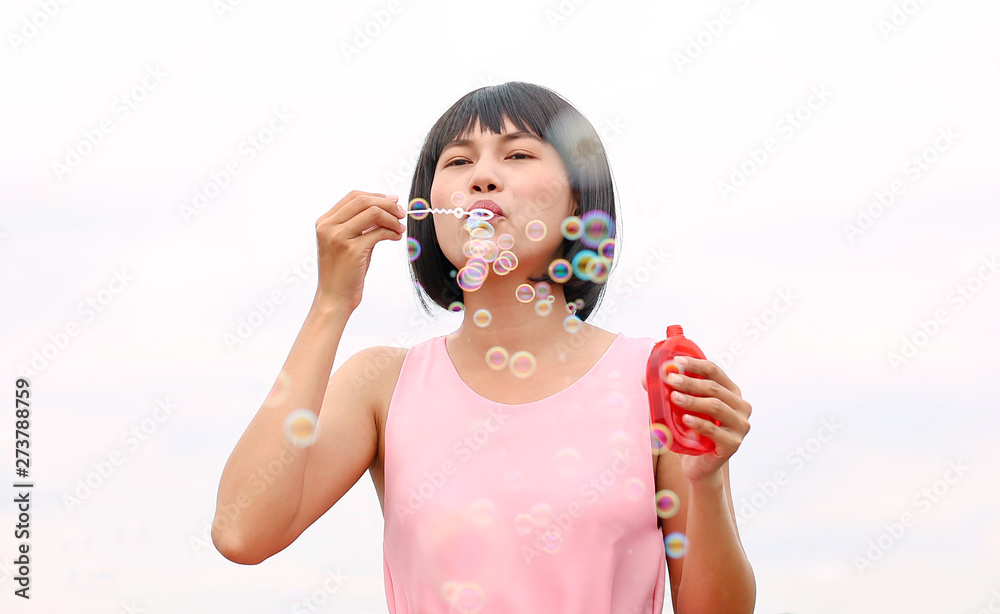 Young asian woman playing bubble outdoor. Young asian woman playing bubble outdoor.