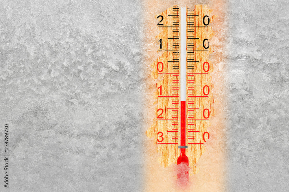 Thermometer on a frosty winter window. Outdoor temperature minus 12 degrees  celsius Stock Photo