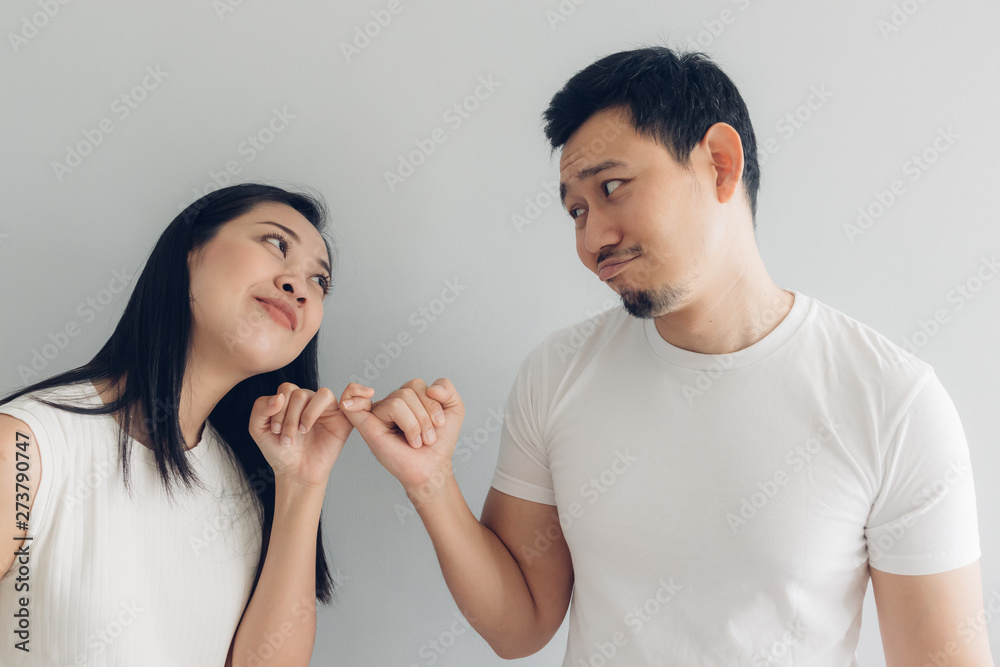 Sulk and reconcile couple lover in white t-shirt and grey background. Sulk and reconcile couple lover in white t-shirt and grey background.