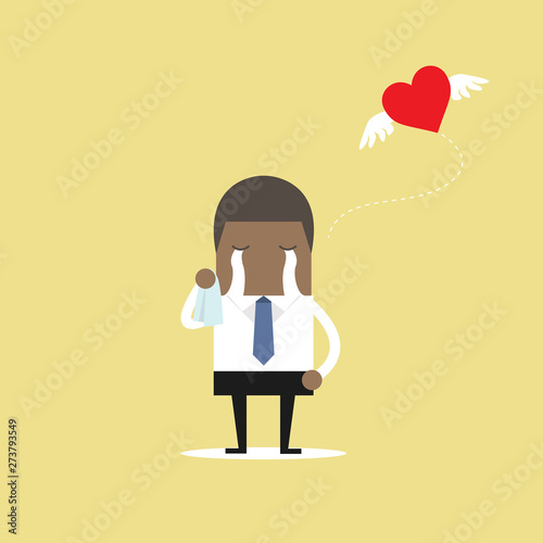 Photos African businessman crying broken heart with heart flying away.