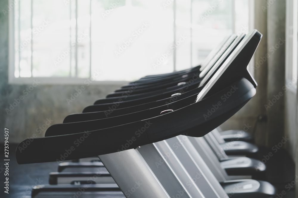 Empty Treadmill line up in Gym fitness training room - obrazy, fototapety, plakaty 