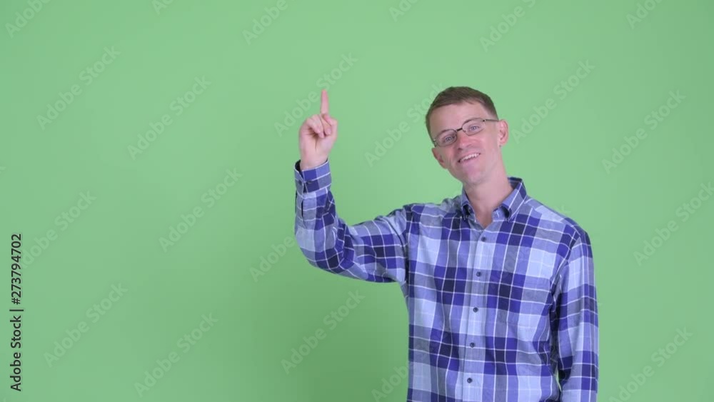 Portrait of happy hipster man talking while pointing up Portrait of happy hipster man talking while pointing up