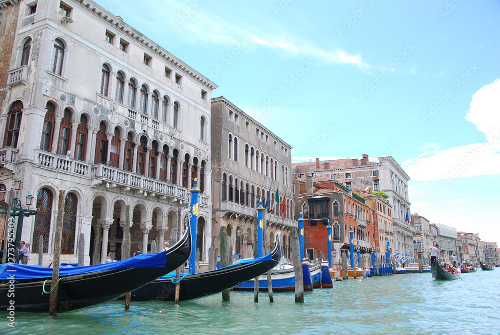 gondola boats in grand canal with blue sky background