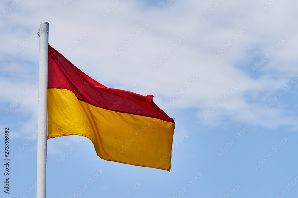 Lifeguard flag and blue sky background Lifeguard flag and blue sky background