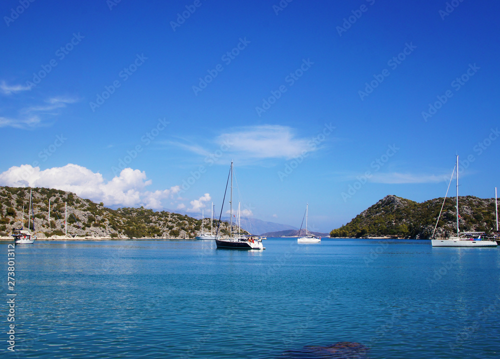 Blue lagoon with yachts. Ships stand near the shore against the backdrop of a beautiful landscape. Blue lagoon with yachts. Ships stand near the shore against the backdrop of a beautiful landscape.