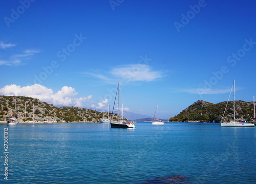 Blue lagoon with yachts. Ships stand near the shore against the backdrop of a beautiful landscape.
