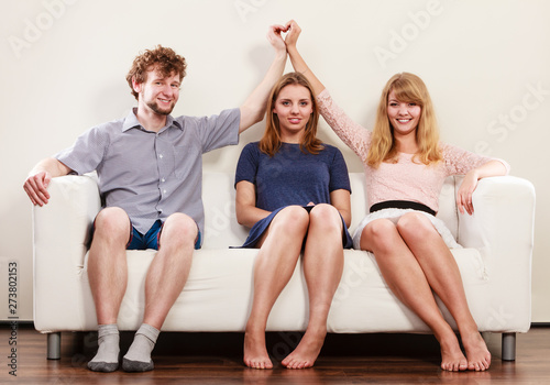 Happy friends sitting on sofa. photo