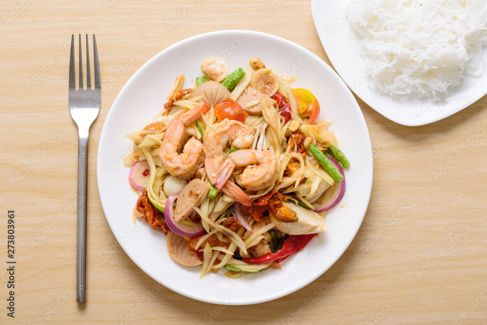 Spicy papaya salad with shrimp and rice noodles, Thai food Spicy papaya salad with shrimp and rice noodles, Thai food