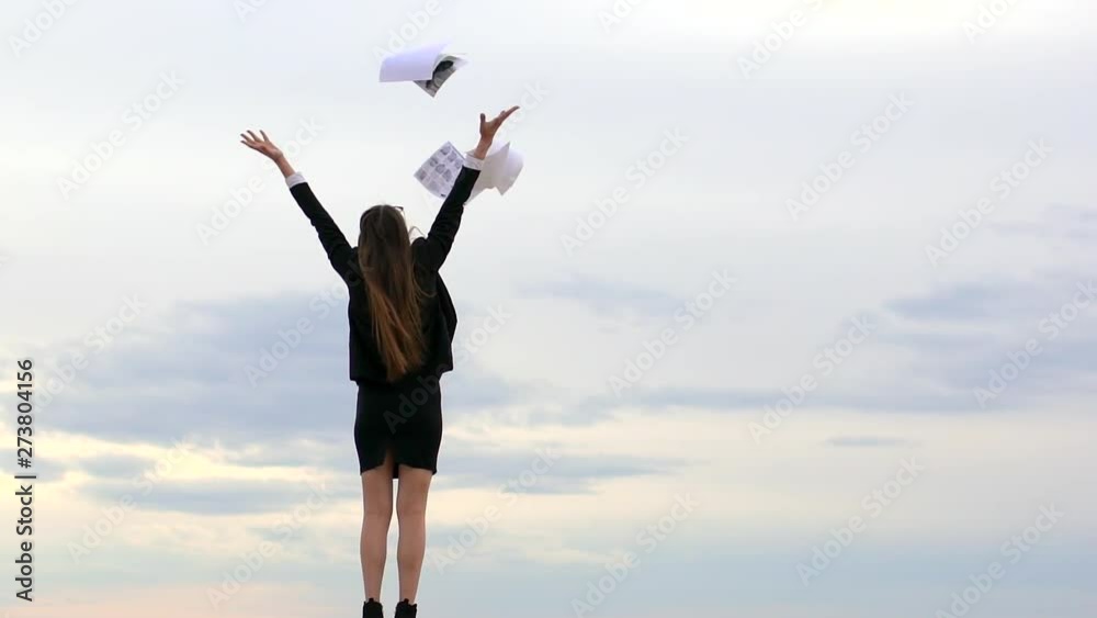 Businesswoman girl female student standing on beach with arms raised, throwing in sky sheets of paper, documents, Business woman enjoying relaxing nature. freedom stress work. calming, no stress relax Businesswoman girl female student standing on beach with arms raised, throwing in sky sheets of paper, documents, Business woman enjoying relaxing nature. freedom stress work. calming, no stress relax
