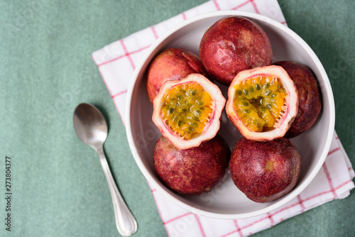 Fresh passion fruit in a bowl, tropical and healthy fruit, top view