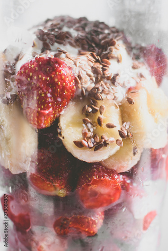 Strawberries smoothie with linseeds and bananas, healthy and useful drink, gray background.