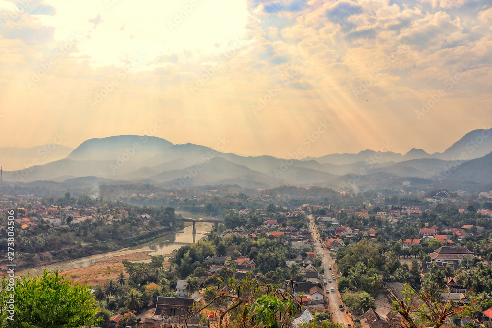 Cityscape of Luang Prabang from the top of Mount Phou Si - views of the city, Nam Khan rivers and the forested mountains - famous and popular touristic sights