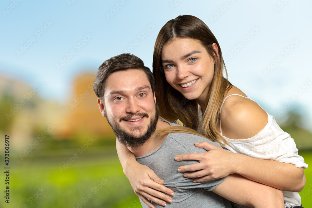 Happy couple embracing and looking at camera Happy couple embracing and looking at camera