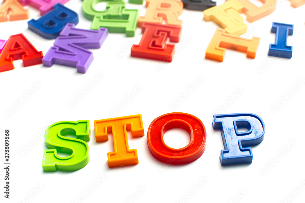 Heap of plastic colored alphabet letters close up. Stop Heap of plastic colored alphabet letters close up. Stop