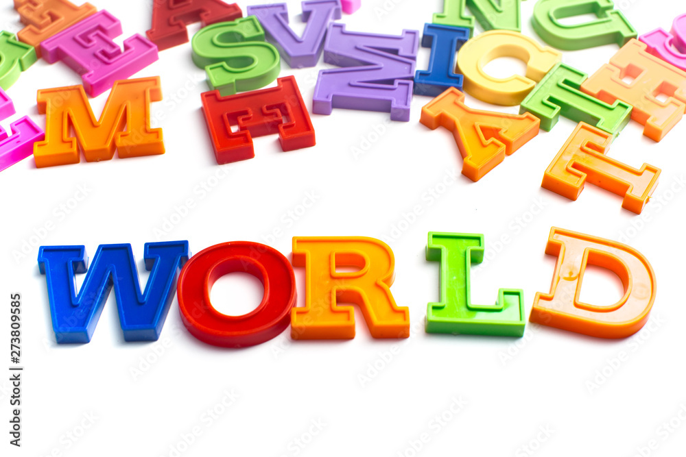 Fototapeta premium Heap of plastic colored alphabet letters close up. World