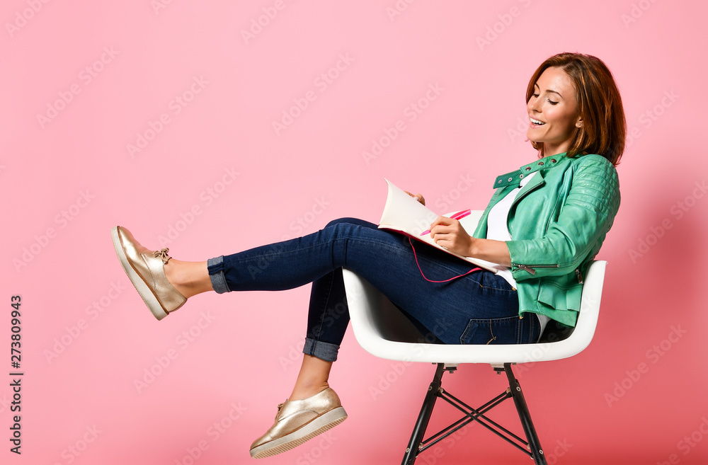 Young woman studying whith notepad in a chair Young woman studying whith notepad in a chair