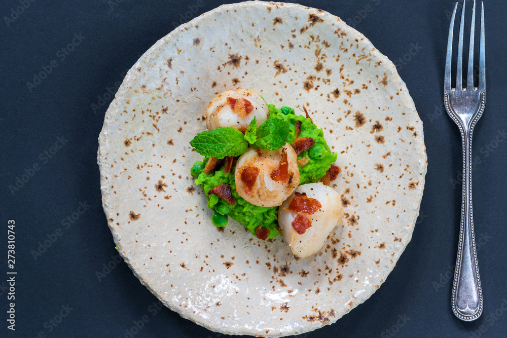 Scallops with minted peas and crispy pancetta - overhead view Scallops with minted peas and crispy pancetta - overhead view